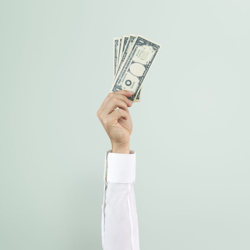 hand holding money finance concept 1 scaled